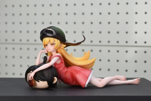 "Premium 1/6 scale Oshino Shinobu Monogatari resin statue. Detailed views showcase her playful pink dress, helmet, and Rubbish-kun plush."