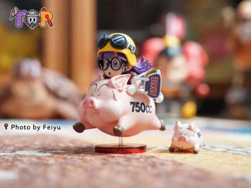 "Iconic Arale WCF Figure playfully riding a cheerful pig, showcasing Dr. Slump's whimsical charm in this collectible statue."