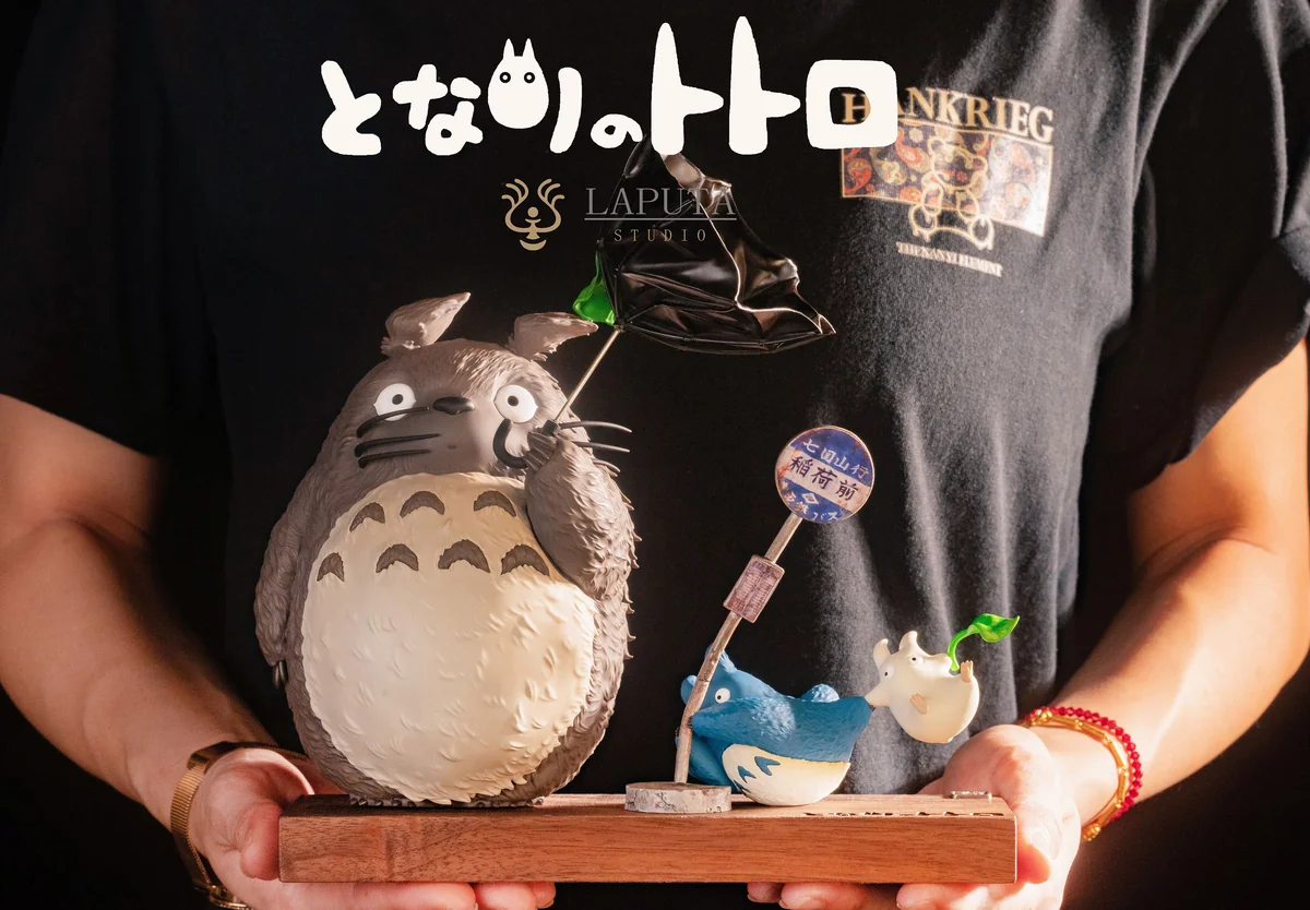"A detailed view of the dynamic Totoro: Wind Advisory resin statue by LAPUTA-studio, showcasing its whimsical wind-swept scene and intricate details."