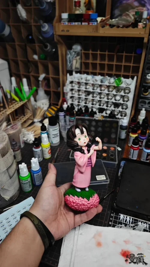 "Extremely limited edition adorable childhood Mitsuri Kanroji Demon Slayer figure by Manzang Studio, sweetly enjoying sakura mochi on a whimsical base."