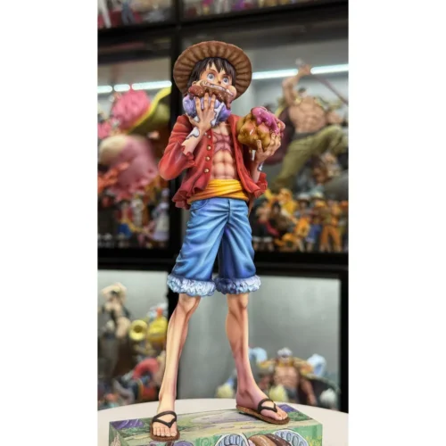 "Vibrant One Piece Luffy figure dynamically devouring a huge cake, a playful and limited edition collectible statue."