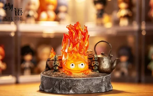 A charming Lying Calcifer with Light resin statue from Howl's Moving Castle, showcasing the luminous fire demon in a relaxed desktop diorama.
