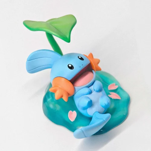"Detailed views of the adorable 1/10 Mudkip Pokémon figure by miumiu Studio, highlighting its cozy chibi aquatic pose and premium PU sculpt."
