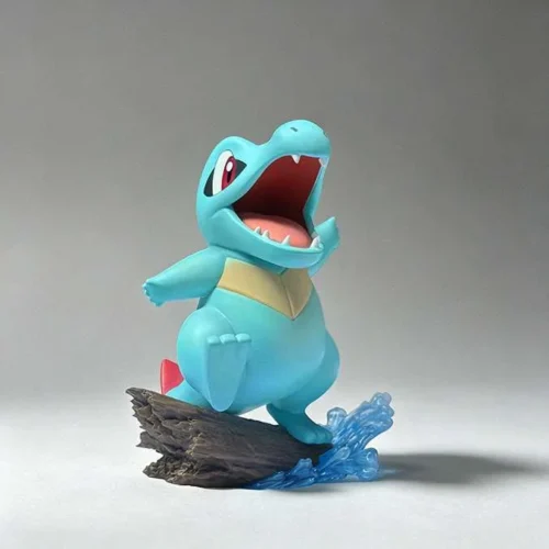 "Detailed view of the Miumiu Studio 1/10 Totodile Pokémon statue, capturing its serene and playful demeanor in a natural setting from multiple angles.