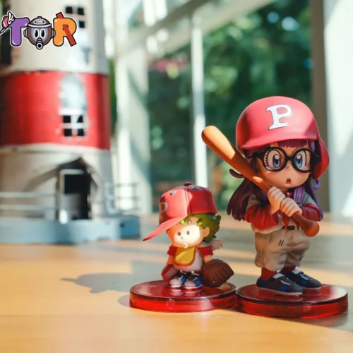 "Vibrant WCF Arale & Gatchan Dr. Slump resin statue. This dynamic Arale figure highlights intricate baseball poses and sculpture details."