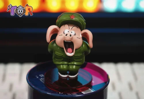 Comedic Oolong Dragon Ball figure by TOR Studio features a pig in a green army uniform, star cap, and open-mouthed comic expression.