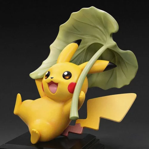 Cheerful Pikachu gliding figure by Miumiu Studio soars under an oversized sculpted green leaf on a glossy black base, limited to 99 pieces.