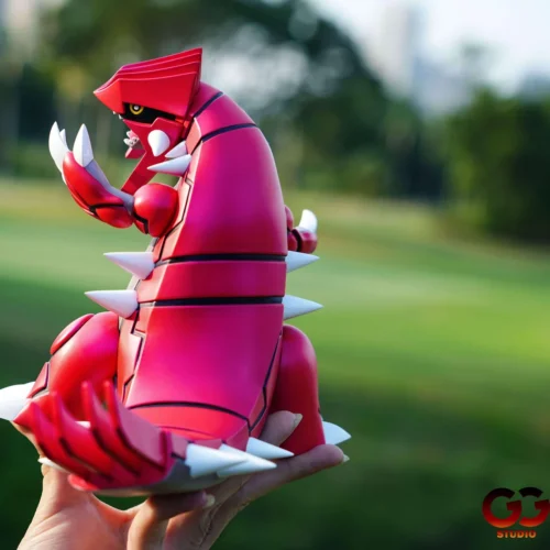 Side view of the limited 50-unit Groudon 1/20 figure by GuGu Studio, showing crimson armor, white spikes, claws, and roaring profile.