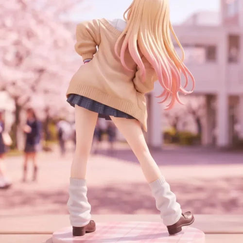 Back view of the 1/6 Marin Kitagawa figure in a tan cardigan and plaid skirt, standing on a pastel blossom base with pink-tipped hair.