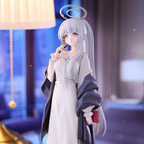This Kotobukiya 1/7 Blue Archive Noa statue features a soft white nightgown, indigo shawl, and luminous blue halo in a quiet bedroom.