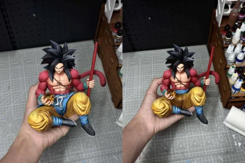 "Limited edition 1/6 Super Saiyan 4 Goku Dragon Ball GT statue by Ranyao Studio. Dynamic sitting pose with staff and rocky base."