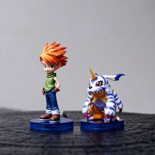 Playful Matt Ishida and Gabumon Digimon figure duo set with free acrylic, bright anime characters on clear blue display bases.
